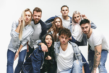 Image showing Group of smiling friends in fashionable jeans