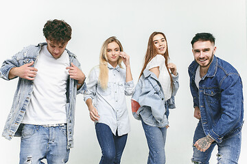 Image showing Group of smiling friends in fashionable jeans