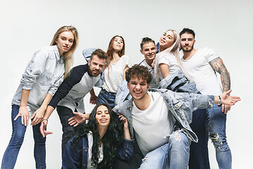Image showing Group of smiling friends in fashionable jeans