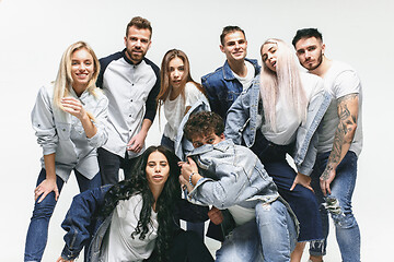 Image showing Group of smiling friends in fashionable jeans