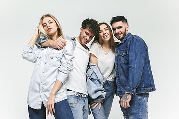 Image showing Group of smiling friends in fashionable jeans