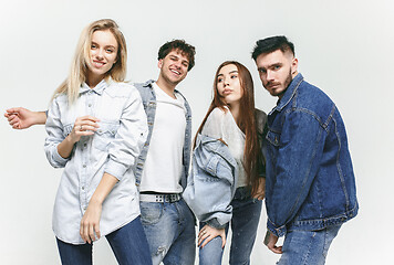 Image showing Group of smiling friends in fashionable jeans