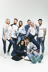 Image showing Group of smiling friends in fashionable jeans