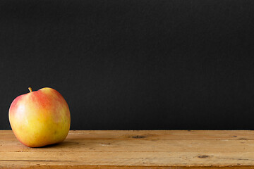 Image showing black background apple wooden table