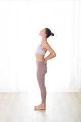 Image showing Portrait of gorgeous active sporty young woman practicing yoga in studio. Beautiful girl practice Ardha Chandrasana,half moon yoga pose. Healthy active lifestyle, working out in gym