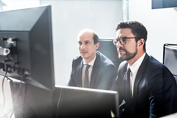 Image showing Business team analyzing data at business meeting in modern corporate office.