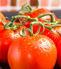 Image showing Bunch of red juicy tomatoes with water droplets in kitchen 