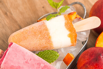 Image showing Homemade raspberries and peach popsicles