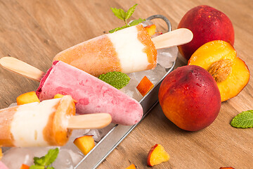 Image showing Homemade raspberries and peach popsicles