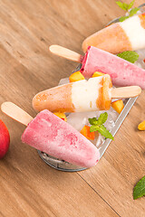 Image showing Homemade raspberries and peach popsicles