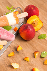 Image showing Homemade raspberries and peach popsicles