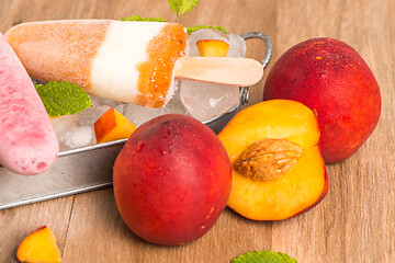 Image showing Homemade raspberries and peach popsicles