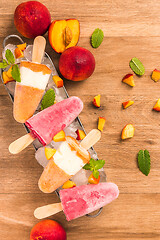 Image showing Homemade raspberries and peach popsicles