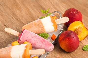 Image showing Homemade raspberries and peach popsicles