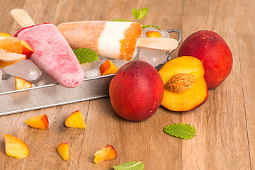 Image showing Homemade raspberries and peach popsicles