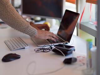 Image showing businessman working using a laptop in startup office