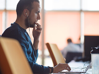 Image showing businessman working using a laptop in startup office