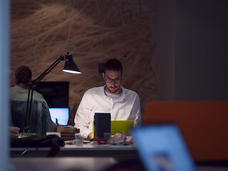 Image showing businessman working using a laptop in startup office