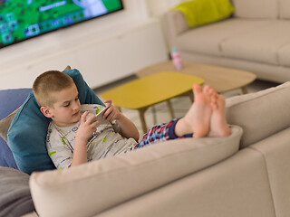 Image showing little boy playing games on smartphone
