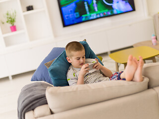 Image showing little boy playing games on smartphone