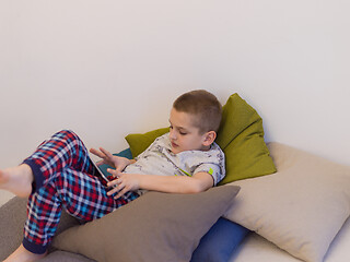 Image showing little boy playing games on tablet computers