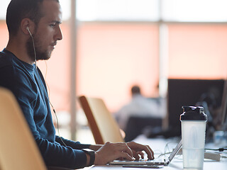 Image showing businessman working using a laptop in startup office