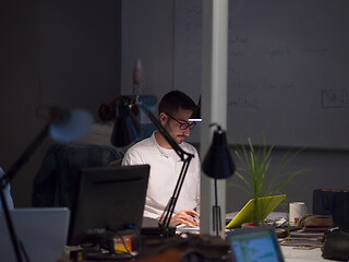 Image showing businessman working using a laptop in startup office