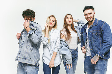 Image showing Group of smiling friends in fashionable jeans