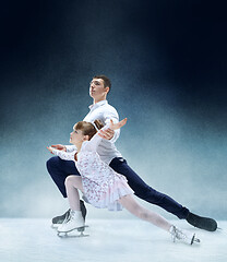 Image showing Little girl figure skating at the indoor ice arena.