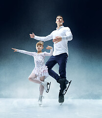 Image showing Little girl figure skating at the indoor ice arena.