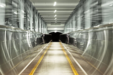 Image showing Moving escalator, blurred abstract background