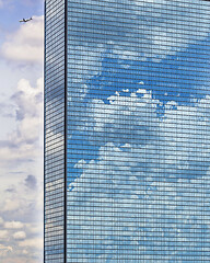 Image showing Clouds reflected in windows of modern office building