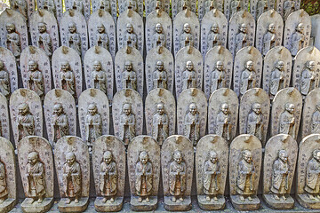 Image showing Little stone statues near ancient japanese shrine