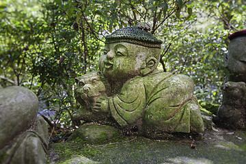 Image showing Tiger - symbol of japanese horoscope. Childish Jizo stone statue wearing knitted and cloth hats with zodiac animal.