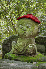 Image showing Jizo stone statue wearing knitted and cloth hats.