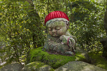 Image showing Sheep - symbol of japanese horoscope. Jizo stone statue wearing knitted and cloth hats.