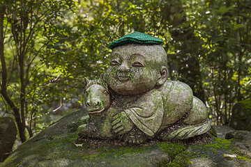 Image showing Horse - symbol of japanese horoscope. Childish Jizo stone statue wearing knitted and cloth hats with zodiac animal.