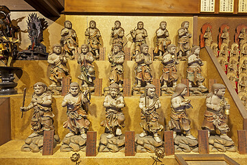 Image showing Little wooden statues in ancient japanese shrine