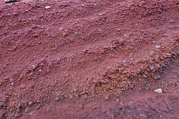 Image showing A cut of soil with rocks and red soil