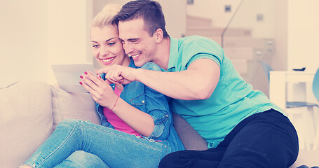 Image showing couple relaxing at  home with tablet computers