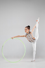 Image showing The teenager girl doing gymnastics exercises isolated on white background