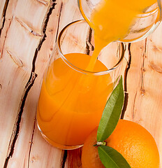 Image showing Pouring Orange Juice Means Tropical Fruit And Refresh 