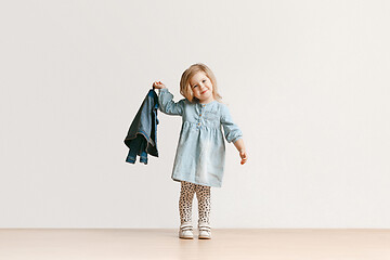 Image showing Full length portrait of cute little kid in stylish jeans clothes looking at camera and smiling