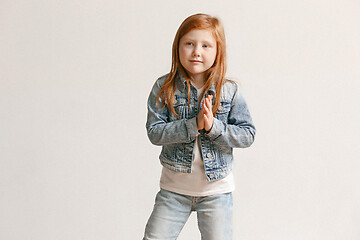 Image showing portrait of cute little kid in stylish jeans clothes looking at camera and smiling