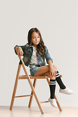 Image showing Full length portrait of cute little kid in stylish jeans clothes looking at camera and smiling