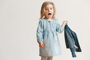 Image showing Full length portrait of cute little kid in stylish jeans clothes looking at camera and smiling