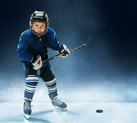 Image showing Little boy playing ice hockey