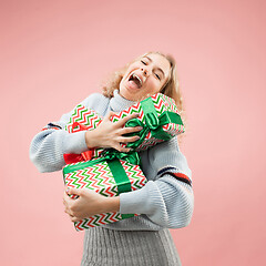 Image showing Woman with big beautiful smile holding colorful gift boxes.