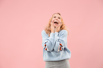 Image showing The happy business woman standing and smiling against pink background.