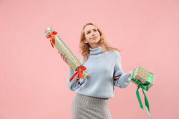 Image showing Woman with big beautiful smile holding colorful gift boxes.